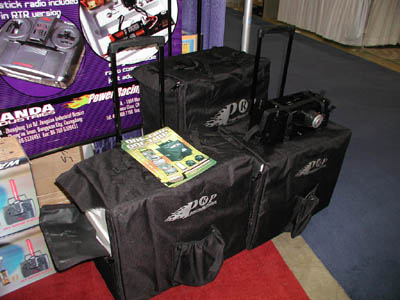 These are the Mega Cargo Carrier backs from Power Racing Products.  Each bag features a fuel jug compartment, starter box straps, a quad-wheel rack with kickstand, a retractable handle, and sturdy cardboard boxes inside for gear storage. (Click to enlarge)