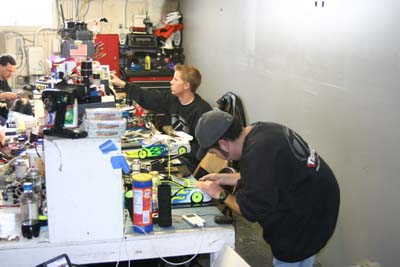 Team Losi drivers Brian Kinwald and Bobby Flack working on their cars during qualifying.  Both made the show in each class they entered. (Click to enlarge)