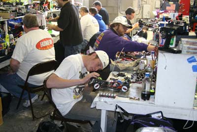 Paul Lemieux works on his XXX-S, with Trinity's Jim Dieter working on motors behind him. (Click to enlarge)