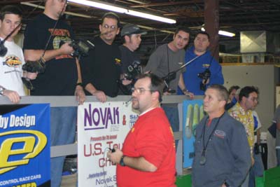 Scotty Ernst and Bob Novak talk to a slew of modified drivers on the stand: (left-to-right) Paul Wynn, Todd Hodge, Eric Desrosiers, Brian Kinwald, Chris Tosolini, and Mike Blackstock. (Click to enlarge)